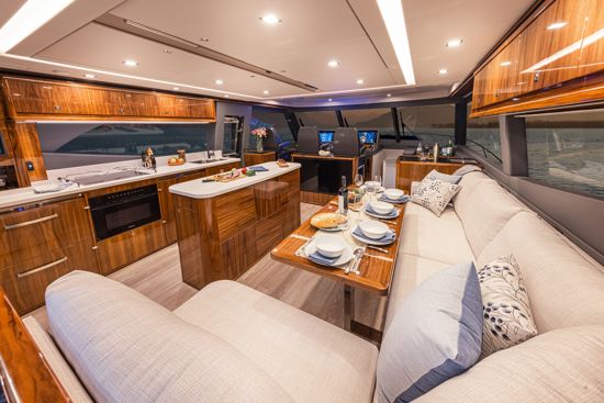 family-hanging-out-on-the-foredeck-of-the-riviera-SUV-645-saloon-and-galley