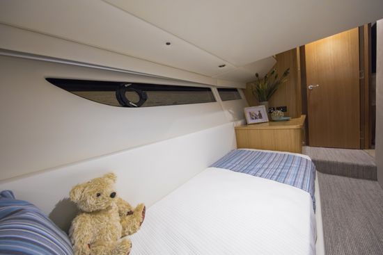 SUV-395-bed-near-the-window-at-the-guest-stateroom
