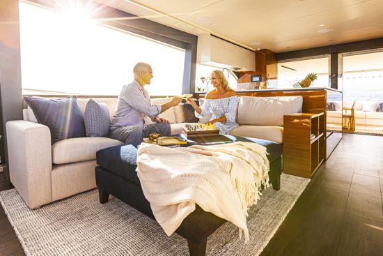 couple-havng-fun-in-the-saloon-of-the-78-motor-yacht