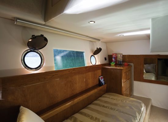 bed-and-windows-in-the-43-open-flybridge-guest-stateroom