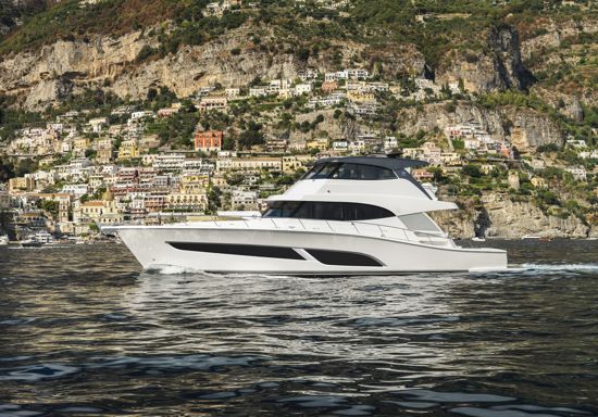 sports-motor-yacht-68-slowly-sailing-with-coastal-town-in-the-background
