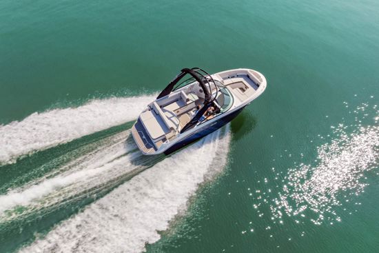 Luxury Sea Ray 230 SDX OB motorboat gliding through waves